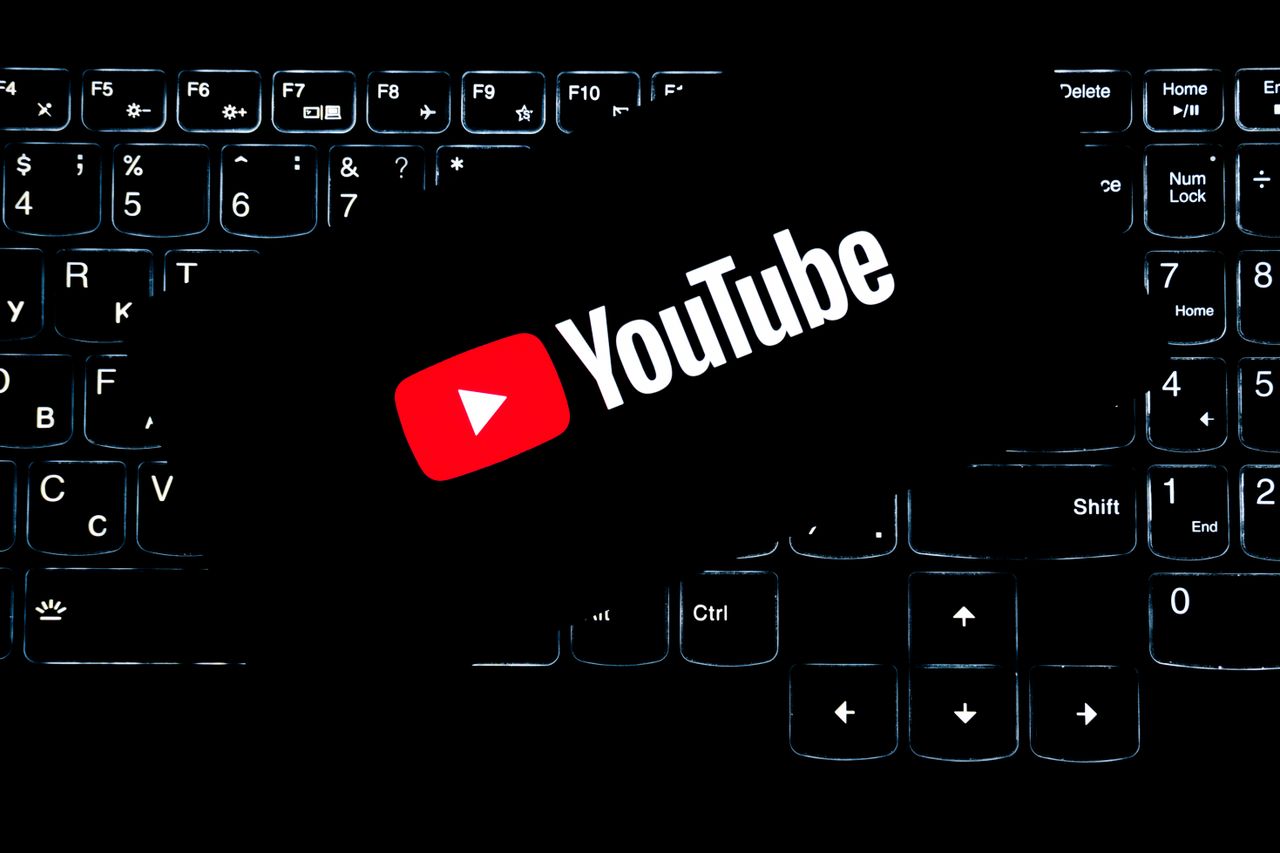 services-01 YouTube logo displayed on a backlit keyboard, representing digital media and online content creation.